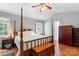 Well-lit bedroom featuring a four-poster bed, hardwood floors, and ample closet space at 1109 Sunnyview Cir, Matthews, NC 28105