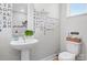 Whimsical half bathroom with unique wall decorations, sleek sink and toilet at 1113 Greenleaf Ave # A, Charlotte, NC 28202