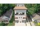 Modern duplex with light gray exterior and balcony, surrounded by lush greenery at 1113 Greenleaf Ave # A, Charlotte, NC 28202