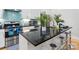 Stylish kitchen island with black countertop, stainless steel appliances, and modern seating at 1113 Greenleaf Ave # A, Charlotte, NC 28202