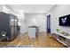Modern kitchen with stainless steel appliances, island seating, and hardwood floors throughout at 1113 Greenleaf Ave # A, Charlotte, NC 28202