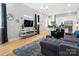 Modern living room with sleek furniture, TV, and a view into the bright kitchen at 1113 Greenleaf Ave # A, Charlotte, NC 28202
