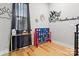 Bright bonus room with hardwood floors, playful decor, and ample natural light, ideal for recreation at 1113 Greenleaf Ave # B, Charlotte, NC 28202