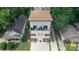 Aerial view of a modern home with white siding and a brown roof surrounded by lush trees in a suburban setting at 1113 Greenleaf Ave # B, Charlotte, NC 28202