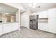 Kitchen features stainless steel refrigerator and bright white cabinets at 11531 Delores Ferguson Ln, Charlotte, NC 28277