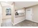 Kitchen featuring gray counters and flooring, white cabinets, and stainless steel appliances at 11531 Delores Ferguson Ln, Charlotte, NC 28277