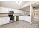 Eat-in kitchen offering stainless steel appliances and white cabinets at 11531 Delores Ferguson Ln, Charlotte, NC 28277