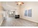 Spacious living room with fireplace, wood-look floors and view to kitchen area at 11531 Delores Ferguson Ln, Charlotte, NC 28277