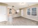 Bright living room with wood-look flooring, large windows and a view to the kitchen at 11531 Delores Ferguson Ln, Charlotte, NC 28277