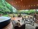 Inviting backyard deck with a hot tub, comfortable seating, and a view of the lush green lawn at 1344 Moonshadow Ln, Shelby, NC 28150