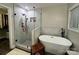 This modern bathroom offers a glass-enclosed shower and a luxurious standalone tub, designed for relaxation at 1344 Moonshadow Ln, Shelby, NC 28150