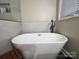 This spacious, free standing tub is complemented by a modern black faucet and a sleek design at 1344 Moonshadow Ln, Shelby, NC 28150