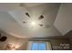 This bedroom ceiling features a fan and a custom stepped design, adding architectural interest at 1344 Moonshadow Ln, Shelby, NC 28150