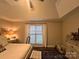 This bedroom boasts a ceiling fan, natural light and neutral tones to create a serene retreat at 1344 Moonshadow Ln, Shelby, NC 28150