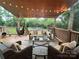 Cozy covered deck with stylish furniture, hammock, and decorative string lights for outdoor relaxation at 1344 Moonshadow Ln, Shelby, NC 28150