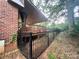 Cozy wooden deck attached to the house with railings and a partial view of the backyard at 1344 Moonshadow Ln, Shelby, NC 28150