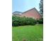 Exterior of brick home showcasing lush green lawn and well-maintained bushes at 1344 Moonshadow Ln, Shelby, NC 28150