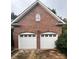 Beautiful brick home featuring a two-car garage with white doors at 1344 Moonshadow Ln, Shelby, NC 28150
