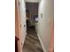 Hallway leading to the living room with hardwood floors and fresh, neutral paint at 1344 Moonshadow Ln, Shelby, NC 28150