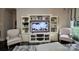 Cozy living room featuring a custom entertainment center and stylish striped armchairs at 1344 Moonshadow Ln, Shelby, NC 28150