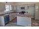 The kitchen features granite countertops, and stainless steel appliances at 153 Brook Creek Dr, Troutman, NC 28166
