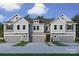 New construction townhome showing stone accents, gray siding, and two-car garages at 176 Quartz Hill Way, Waxhaw, NC 28173