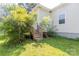 Backyard featuring a wooden staircase leading to the back door and lush greenery at 1818 Stowe Ave, Gastonia, NC 28054