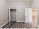 A bedroom with laminate floors, dual closets and a door leading to the next room at 1818 Stowe Ave, Gastonia, NC 28054