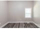 A clean bedroom with neutral walls, laminate flooring, and a window providing natural light at 1818 Stowe Ave, Gastonia, NC 28054