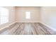 Bright bedroom with two windows and wood look flooring at 1818 Stowe Ave, Gastonia, NC 28054