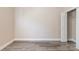 A clean and bright bedroom featuring neutral walls, laminate flooring, and a closet with shelving at 1818 Stowe Ave, Gastonia, NC 28054