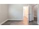 A clean bedroom features neutral paint and flooring with an open door at 1818 Stowe Ave, Gastonia, NC 28054