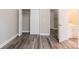 Bedroom with wood-look floors with closet, bathroom and exit door at 1818 Stowe Ave, Gastonia, NC 28054