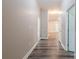 Hallway with neutral walls and wood-look floors at 1818 Stowe Ave, Gastonia, NC 28054