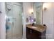 Modern bathroom featuring a glass-enclosed shower, granite countertop, and updated fixtures at 2116 Mcclintock Rd # 122, Charlotte, NC 28205