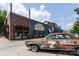 Vintage car parked in front of a whiskey bar with visible signage and exterior decor at 2116 Mcclintock Rd # 122, Charlotte, NC 28205