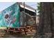 Coffee shop, featuring outdoor seating and a vibrant mural at 2116 Mcclintock Rd # 122, Charlotte, NC 28205