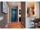 Inviting condo foyer featuring stylish hardwood floors, a vibrant blue door, and convenient kitchen access at 2116 Mcclintock Rd # 122, Charlotte, NC 28205