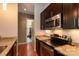 Modern kitchen featuring stainless steel appliances, granite countertops, and dark wood cabinets at 2116 Mcclintock Rd # 122, Charlotte, NC 28205