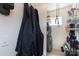 Functional laundry room with washer, dryer, shelving for storage, and a convenient coat rack at 2116 Mcclintock Rd # 122, Charlotte, NC 28205