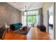 Living room with hardwood floors, exposed ductwork, and access to a private balcony with outdoor seating at 2116 Mcclintock Rd # 122, Charlotte, NC 28205