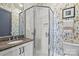 Bathroom featuring a glass enclosed shower, white cabinets and countertop, and patterned wall paper at 2312 Selwyn Ave # 502, Charlotte, NC 28207