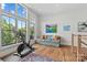 Bonus room boasts large windows and an exercise bike next to a couch with orange pillows at 2312 Selwyn Ave # 502, Charlotte, NC 28207