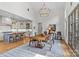 Open dining area with a modern chandelier and adjoined kitchen featuring an island at 2312 Selwyn Ave # 502, Charlotte, NC 28207