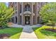 Elegant entryway with brick pillars, a modern glass door, and a lush lawn at 2312 Selwyn Ave # 502, Charlotte, NC 28207