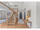 Welcoming entryway with wood staircase, hardwood floors, and high ceilings at 2312 Selwyn Ave # 502, Charlotte, NC 28207