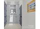 Hallway has linen closet, artwork, and white paint with dark doors at 2312 Selwyn Ave # 502, Charlotte, NC 28207