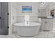 Luxurious main bathroom featuring a soaking tub, skylight, and modern fixtures at 2312 Selwyn Ave # 502, Charlotte, NC 28207