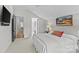 Bright main bedroom with a cozy bed, a view into the main bathroom and a flat screen TV at 2312 Selwyn Ave # 502, Charlotte, NC 28207