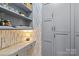 Walk-in pantry featuring custom shelving, wallpaper and plenty of storage space at 2312 Selwyn Ave # 502, Charlotte, NC 28207